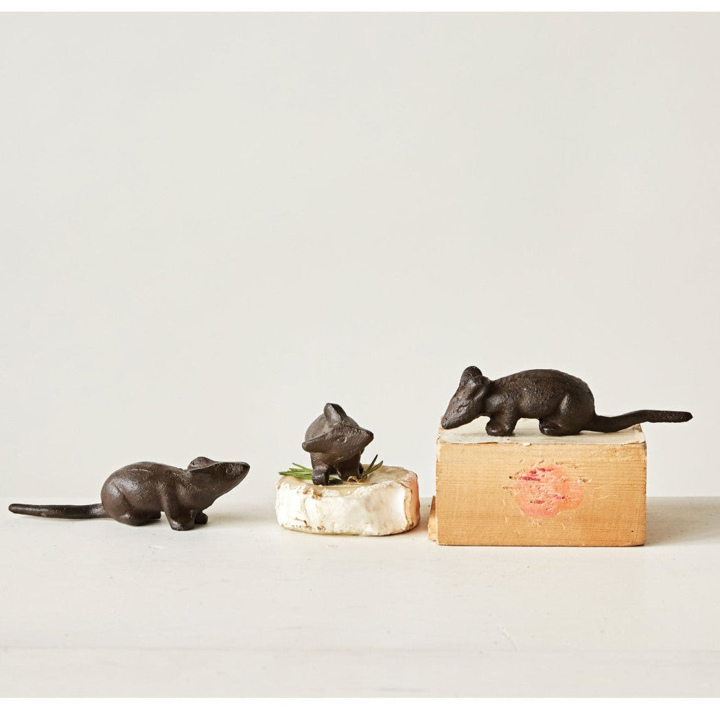 Three small bronze rat figurines on a white background